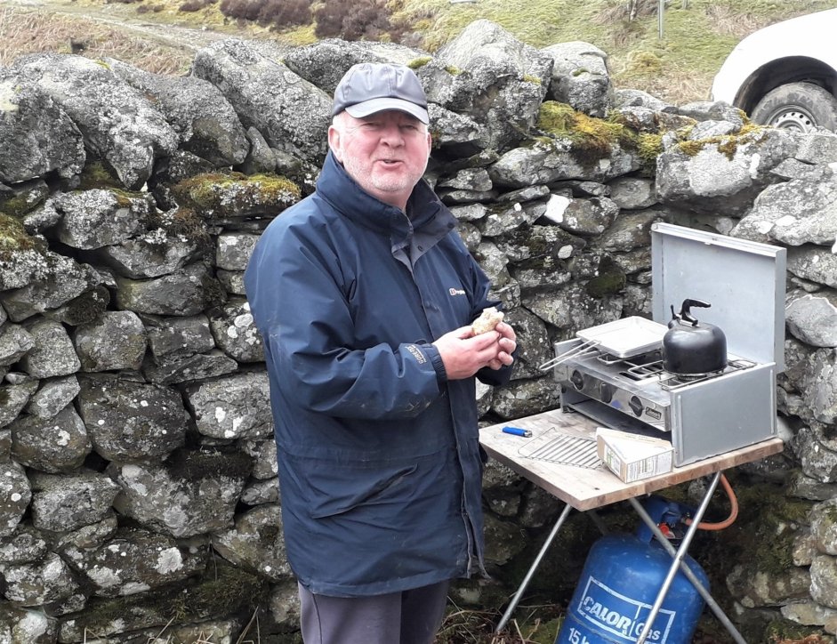 Volunteer Tom Davies and the grill he provided for the project